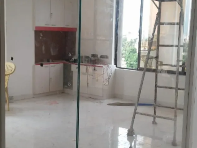 Clear glass partition around an unfinished cabin, the room fully visible through it