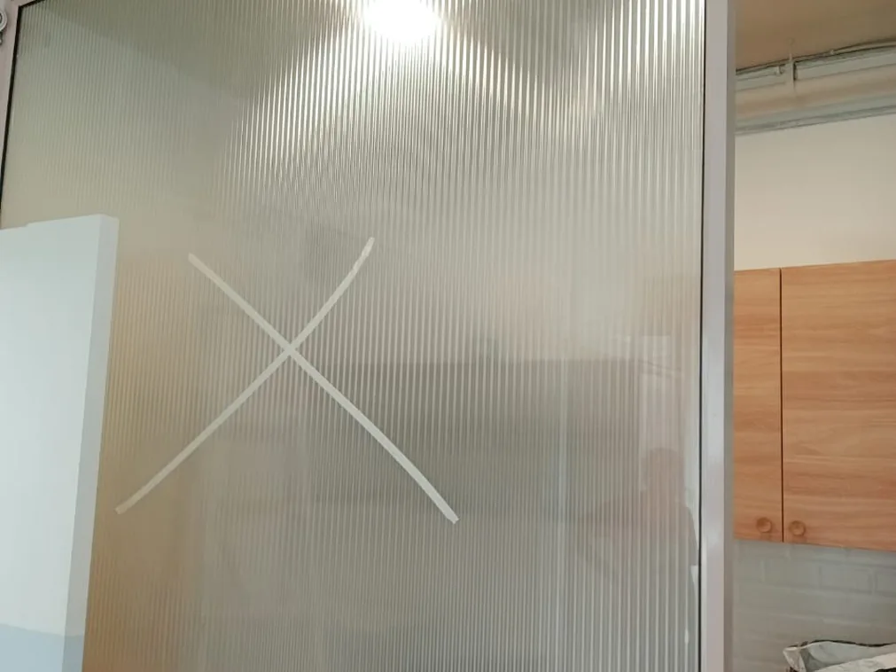 The same partition after reeded film, the kitchen behind it now softened to an outline