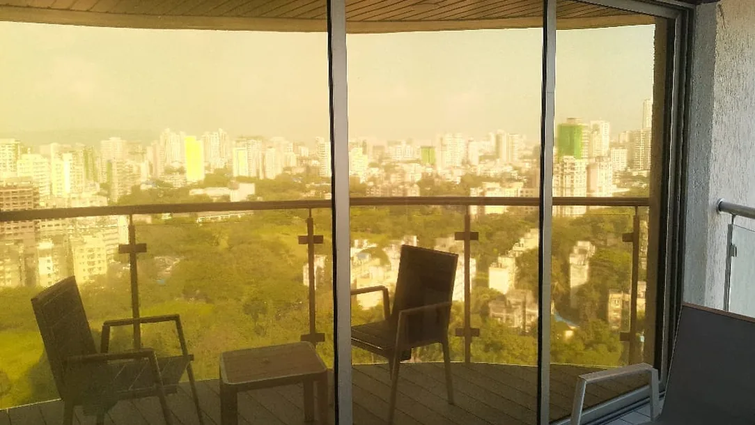Bronze sun control film on a balcony's wraparound glazing