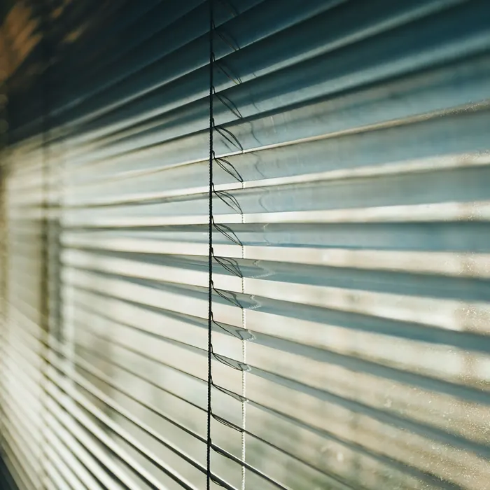 Metal venetian slats catching daylight