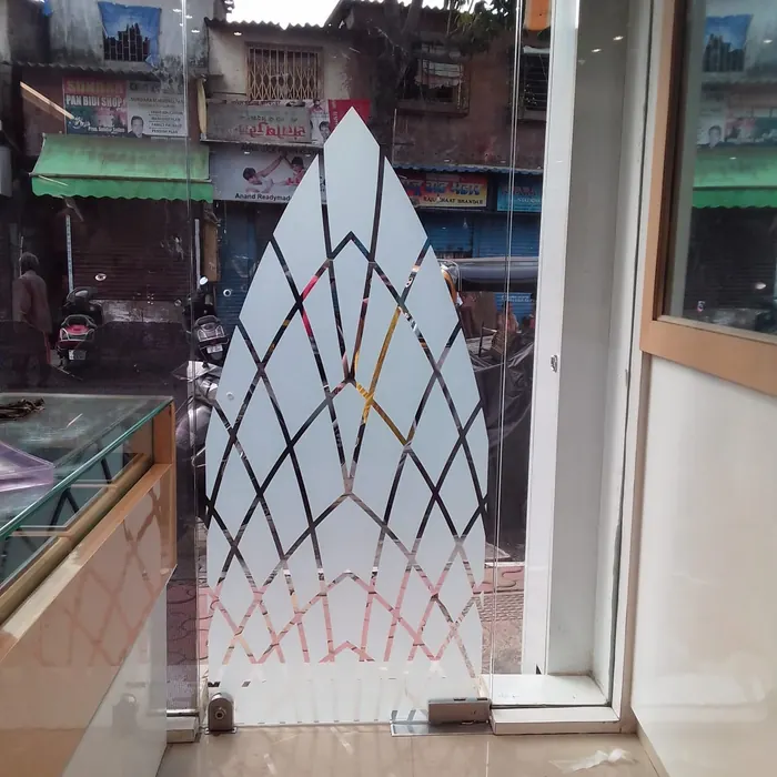 Etched decorative panel set into a shopfront window