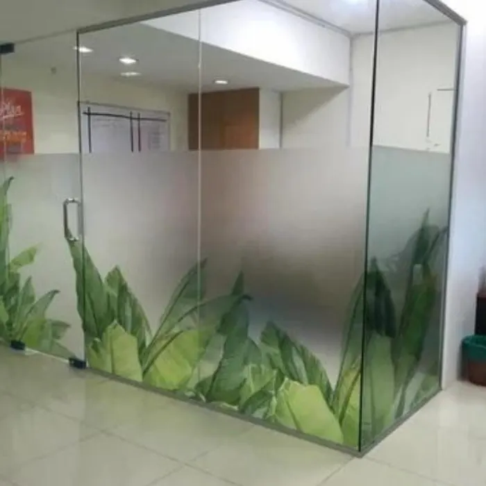 Green leaf gradient printed along a glass office wall