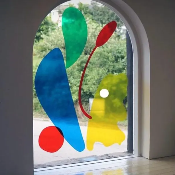 Coloured film shapes applied to an arched window