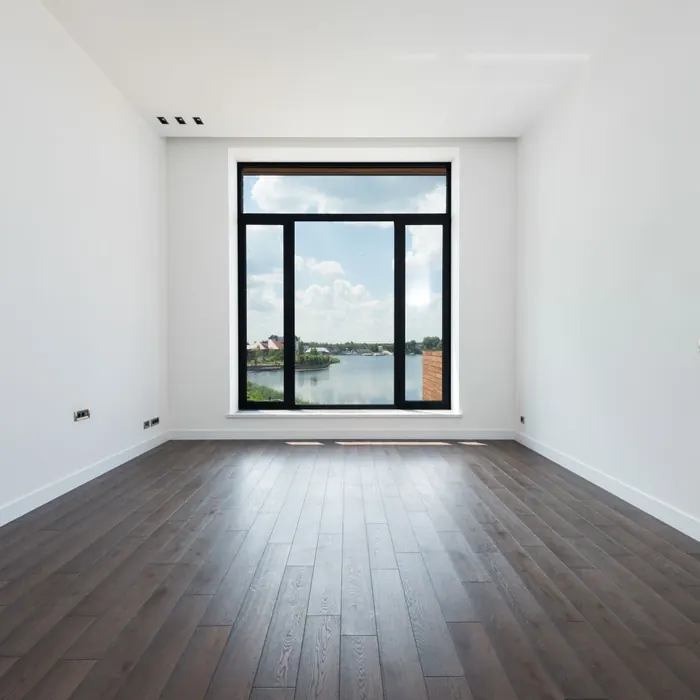Plank flooring laid wall to wall in an empty room