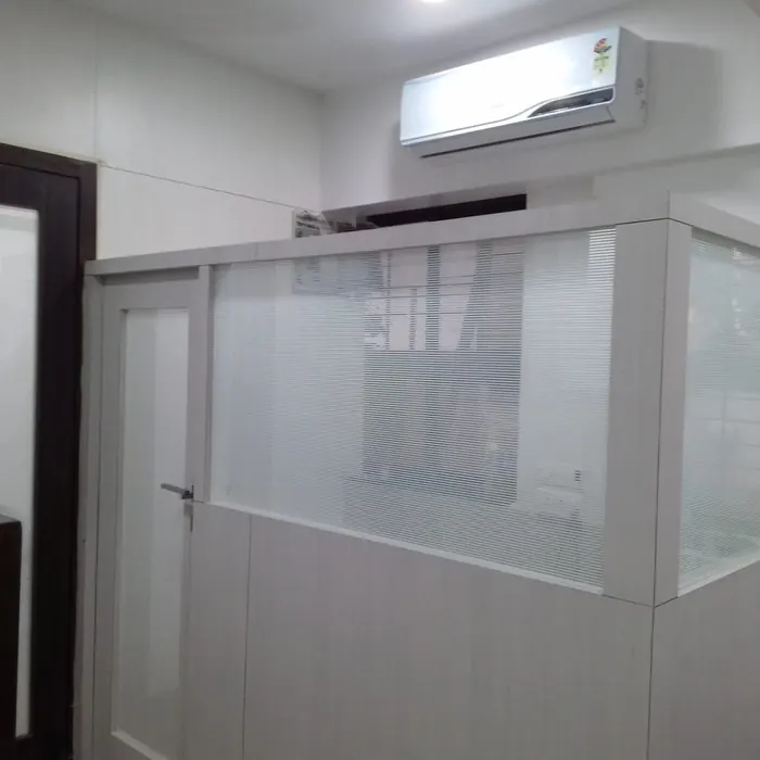 Frosted glass cabin built into a white office interior