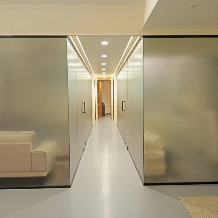 Frosted cabin walls along a lit office corridor
