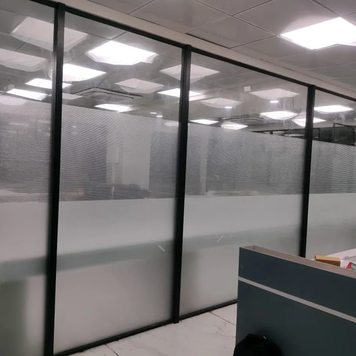 Open-plan office divided by frosted glass screens
