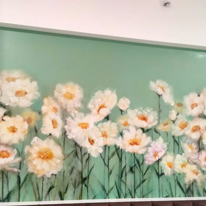 Hand-painted daisy panel set into a back-lit glass wall