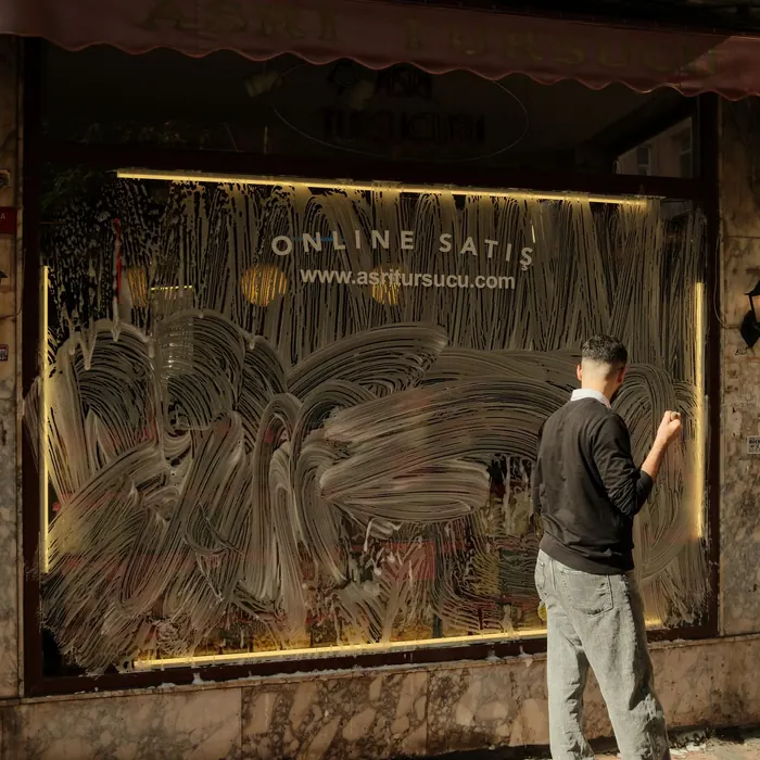 Vandalised storefront glass being inspected