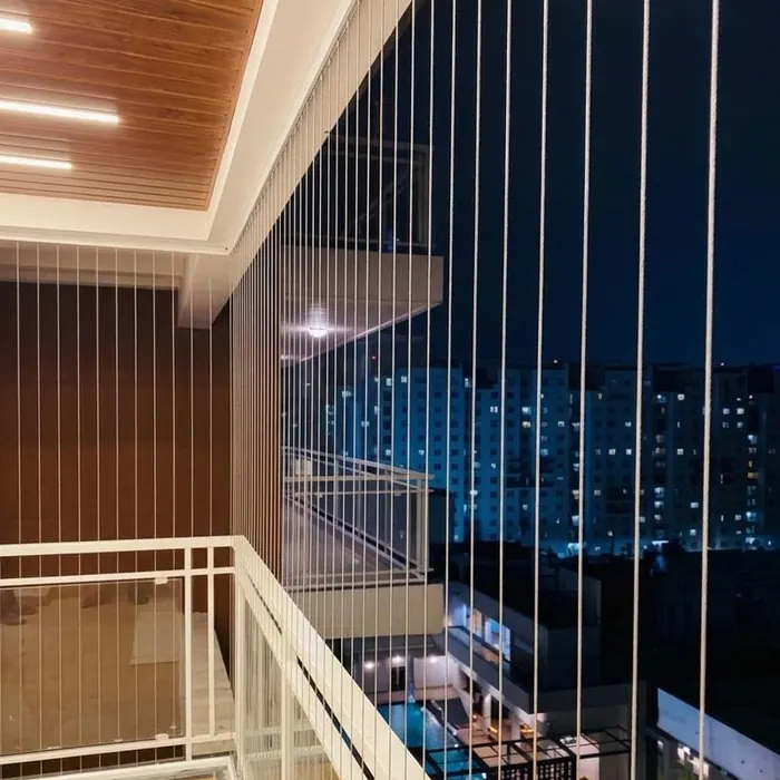 Tensioned grille on a high-rise balcony after dark