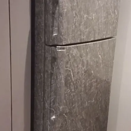 Refrigerator wrapped in a marble-effect film