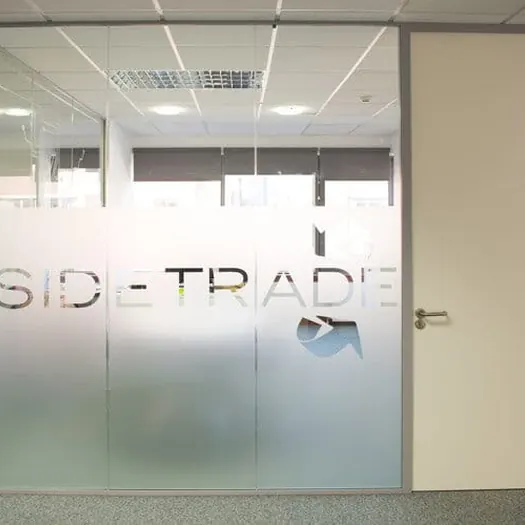 Company name cut into the frosted film of an office partition