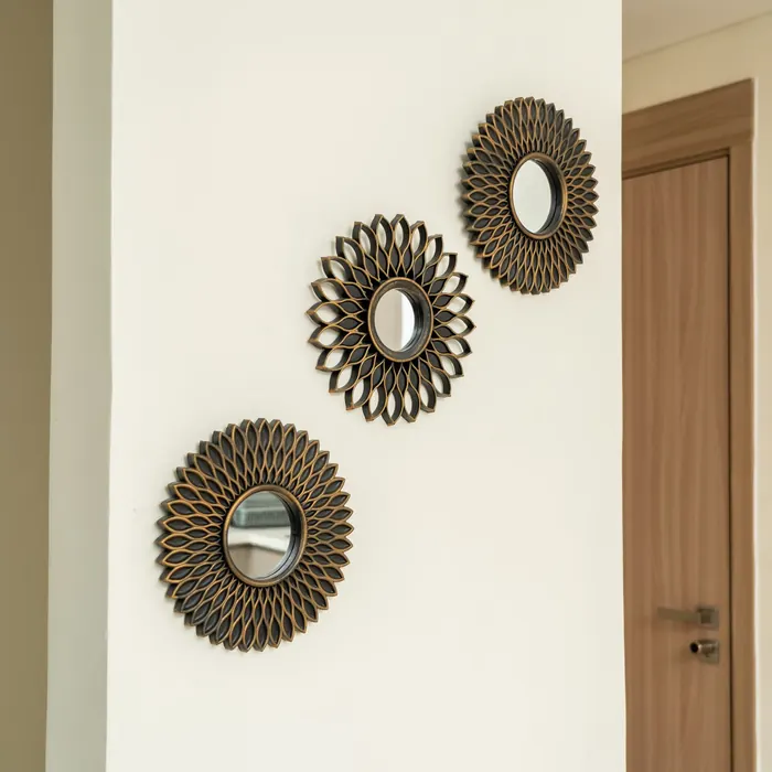 Sunburst mirrors grouped on a hallway wall