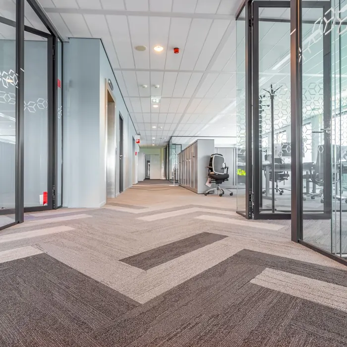 Glass partition walls along an office hall
