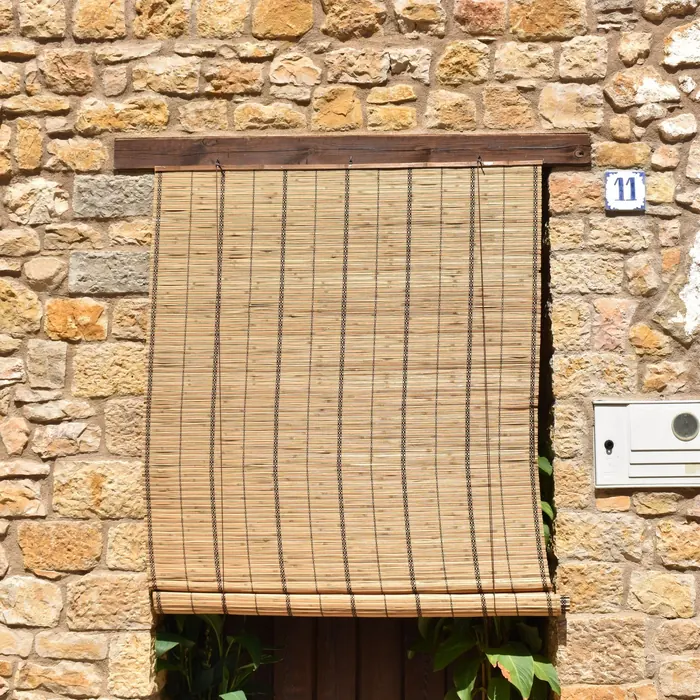 Roll-down outdoor blind over a stone-framed doorway