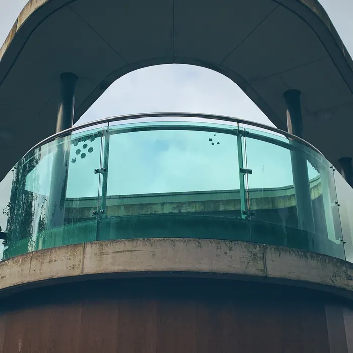 Curved glass balustrade on a raised deck