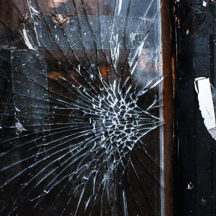 Impact crack spreading across a framed pane