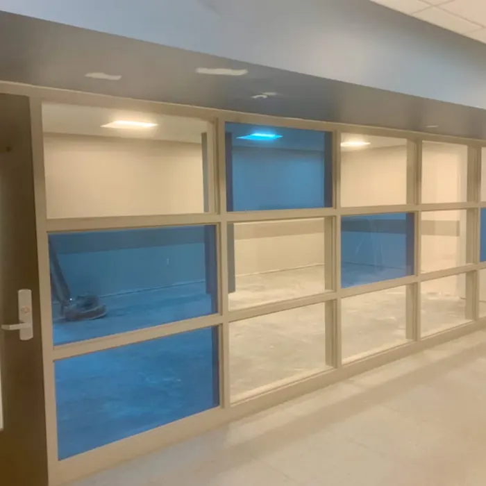 Blue translucent film panels in a corridor screen