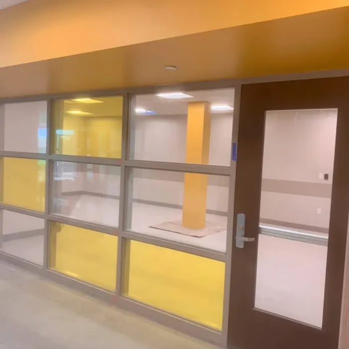 Yellow and white film panels beside classroom doors