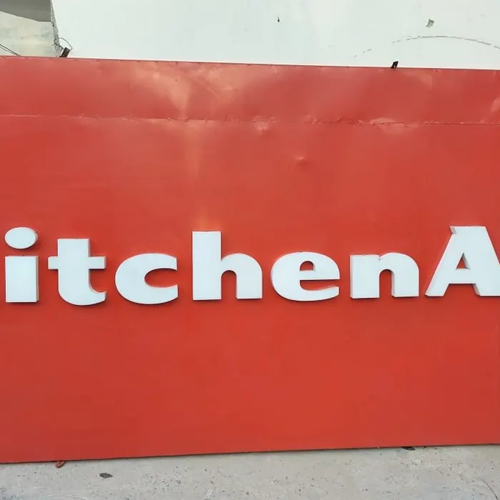 Brand lettering fixed to a red retail fascia