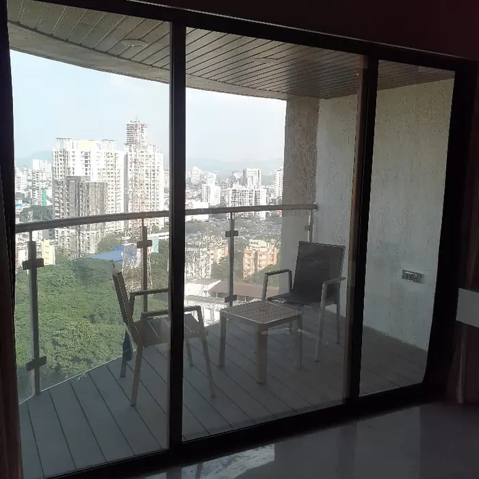 Balcony sliding doors filmed against a city skyline