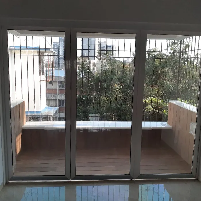 Sliding balcony doors with a safety grille behind