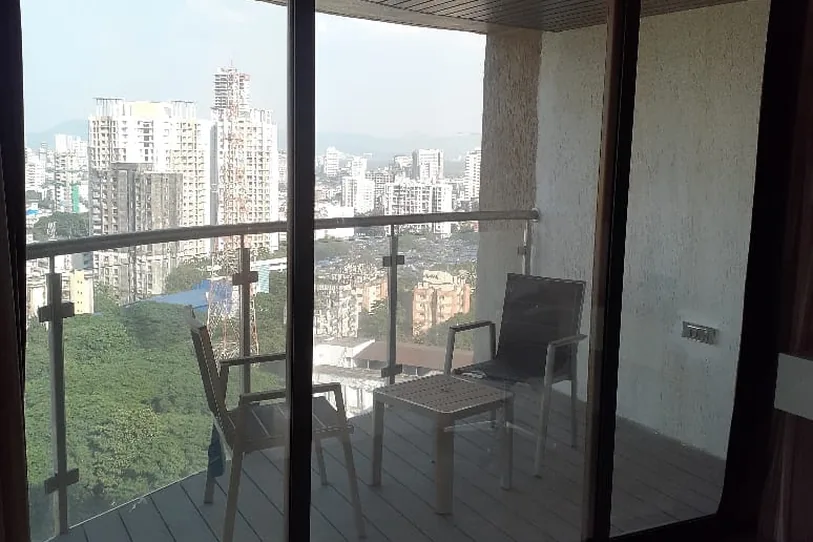 Apartment balcony doors filmed against a clear view of the city