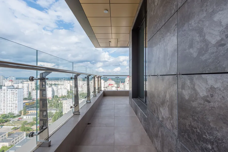 Glass balustrade wrapping a terrace above the city