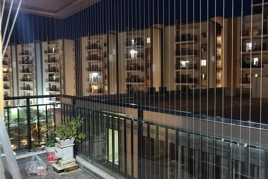Tensioned grille cables across a balcony opening