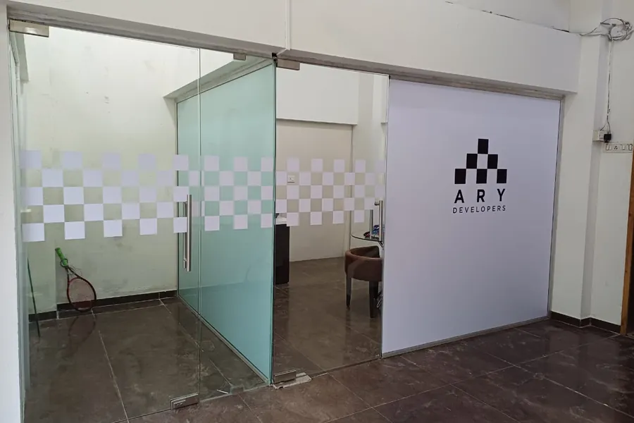 Developer branding printed across a glass office partition