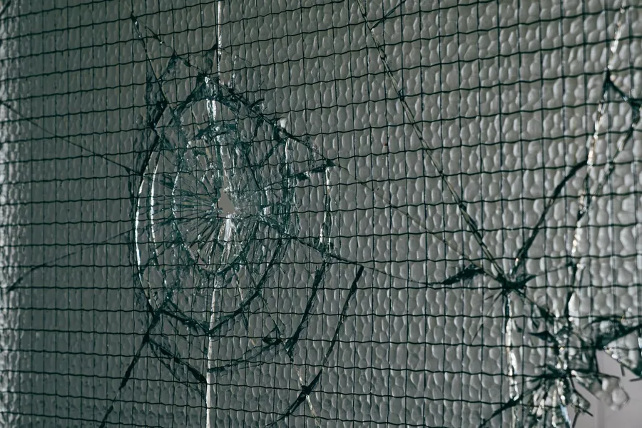 Impact-shattered pane held together in its frame