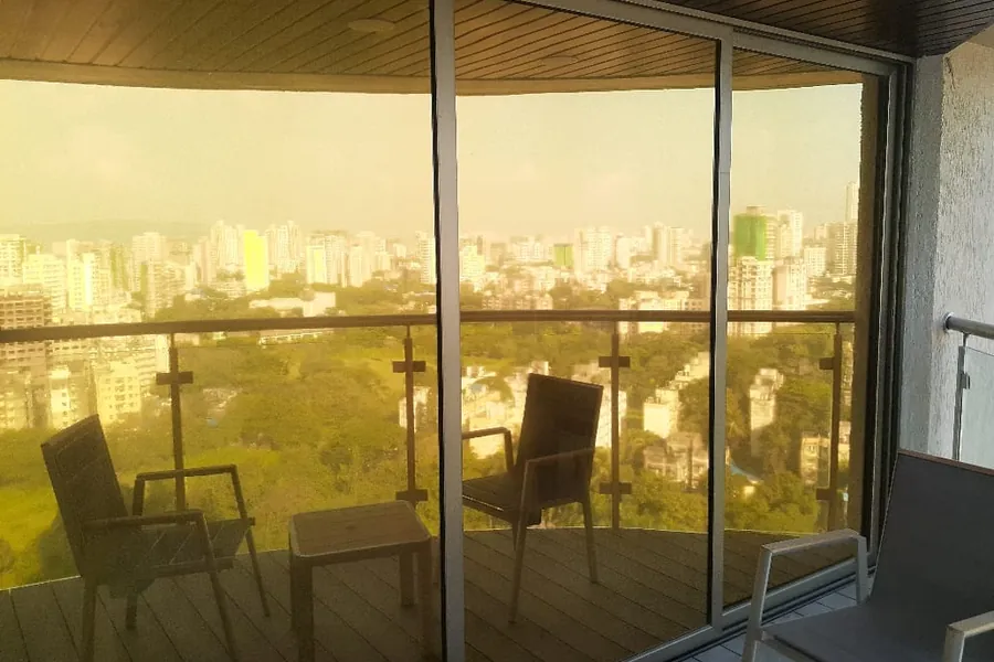 Bronze sun control film on a high-rise balcony's wraparound glazing