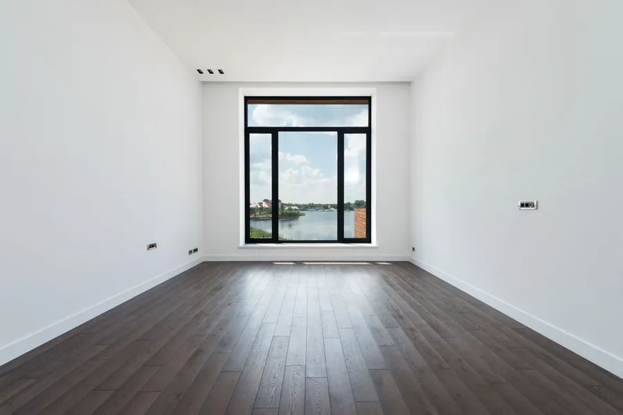 Plank flooring laid wall to wall in an empty room