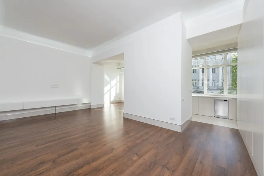 Wooden plank flooring running through an empty apartment