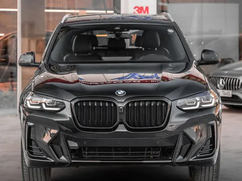 Front windshield of a car filmed and parked at a detailing bay