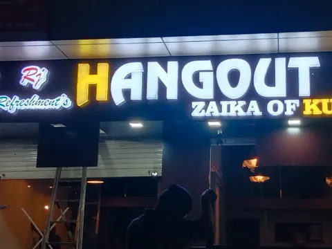 Illuminated 3D letters above a snack bar frontage