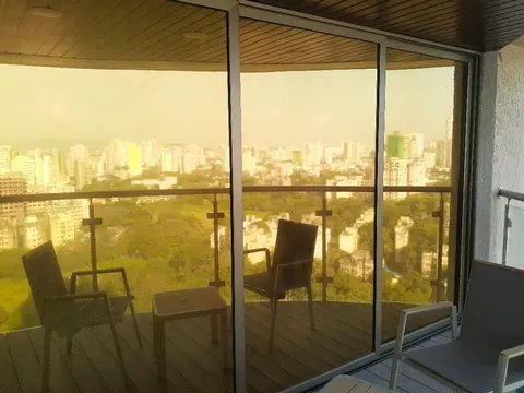 Bronze sun control film on a high-rise balcony's wraparound glazing