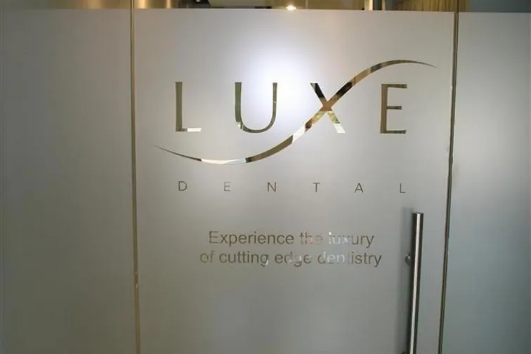 Clinic entrance with the practice name frosted onto the glass door