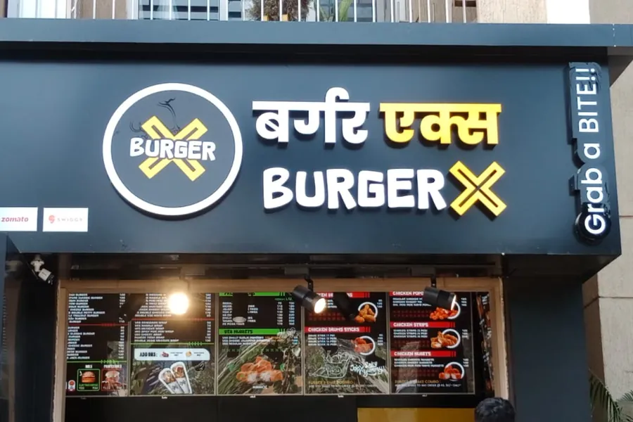 Illuminated fascia sign and menu graphics on a food outlet frontage