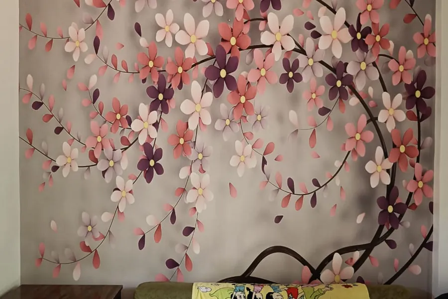 Blossom branch mural printed across a bedroom feature wall
